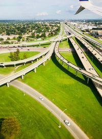 High angle view of road amidst field against sky