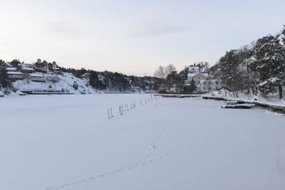 Snow covered land against sky