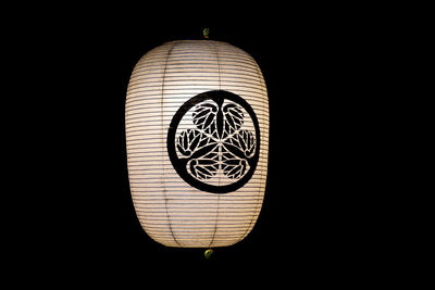 Directly below shot of illuminated lantern against black background