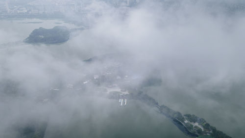 Aerial view of mountains against sky during winter