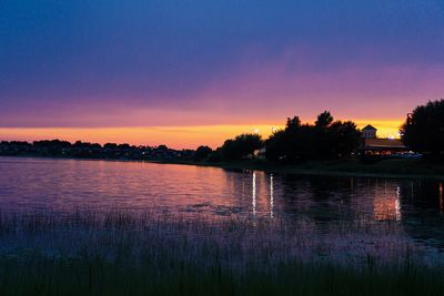 Scenic view of lake against romantic sky at sunset