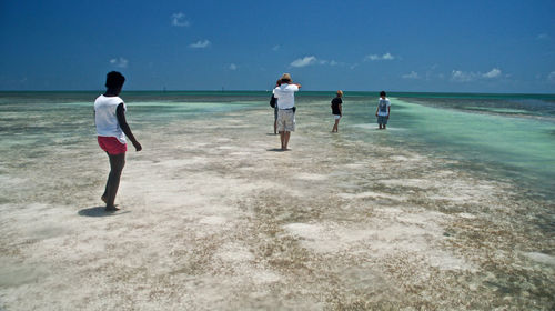 People on shore against sky at florida keys