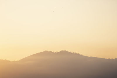 Scenic view of silhouette mountain against sky during sunset