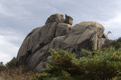 Low angle view of rock formations against sky