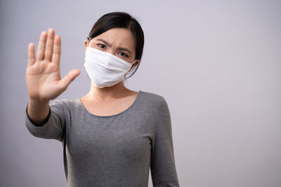 Portrait of a woman against white background