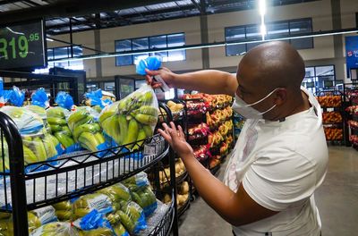 Midsection of man holding ice cream at store