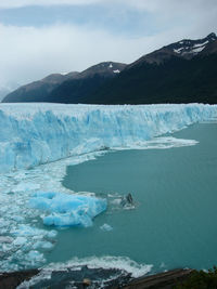Scenic view of sea and mountains against sky