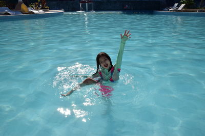 Portrait of boy swimming in pool