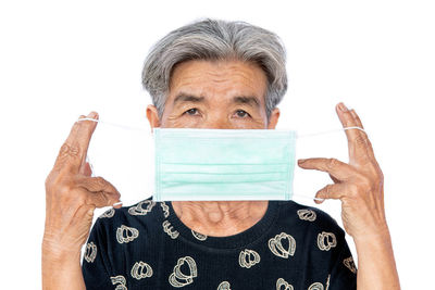 Portrait of mid adult woman against white background