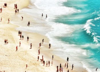 High angle view of people at beach during sunny day