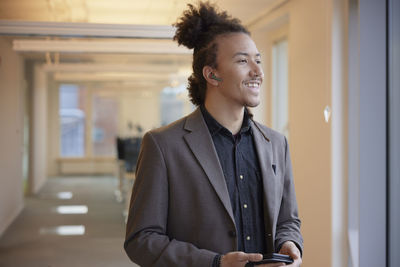 Smiling man standing in office