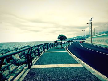 Surface level of empty road along calm sea