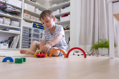 Portrait of boy playing with toy blocks at home