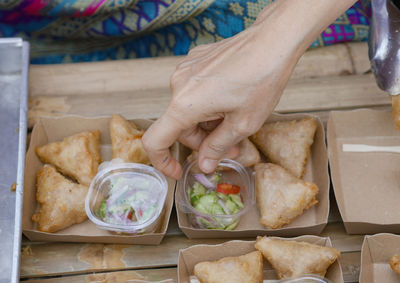 Cropped hand of person preparing food