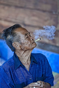 Midsection of woman smoking cigarette