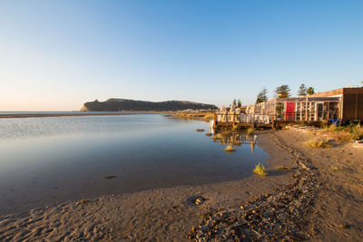 Scenic view of beach against clear sky