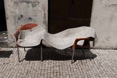 High angle view of carpet drying on chairs