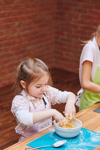 Girls preparing food in kitchen at home