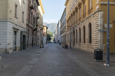 Narrow street amidst buildings in city