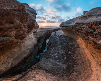 Scenic view of rock formation against sky during sunset