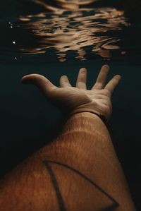 Close-up of man hand in water