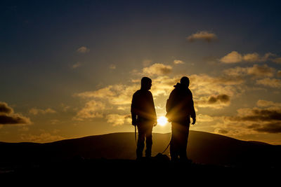Silhouette man standing against sky during sunset
