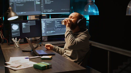 Rear view of man working in office