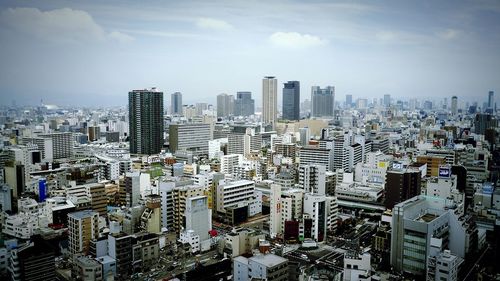 Cityscape against cloudy sky