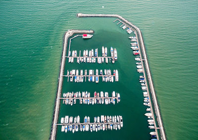 High angle view of warning sign on pier over sea