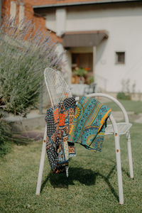 Umbrella on chair in lawn outside house