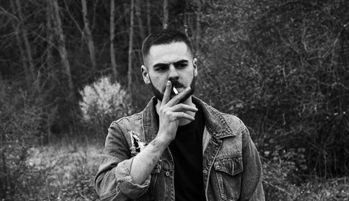 Portrait of young man smoking cigarette