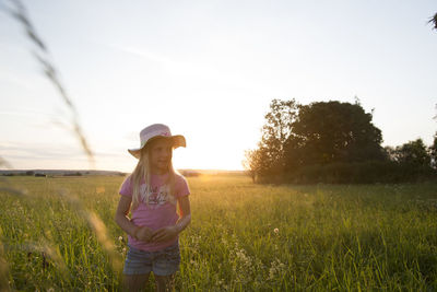 Woman standing on field against sky