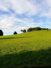 Scenic view of field against cloudy sky