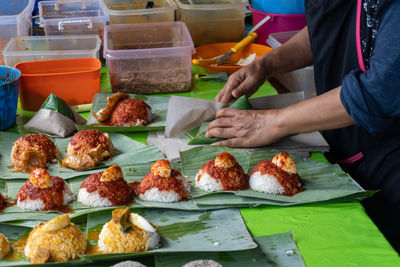 Man working on display at market stall