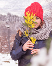 Woman holding umbrella during winter