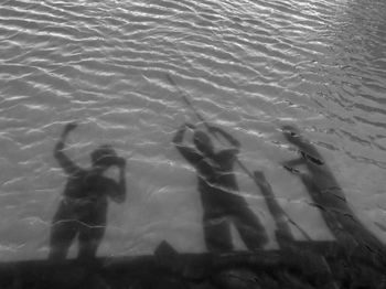 High angle view of people swimming in sea