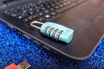 Close-up of lock with laptop on table