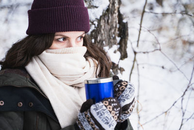 Portrait of man with coffee cup in winter