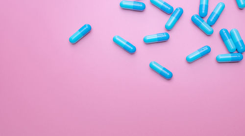 High angle view of pills on yellow background