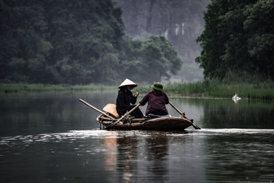 People in boat on lake