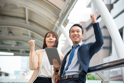 Business people standing on footbridge