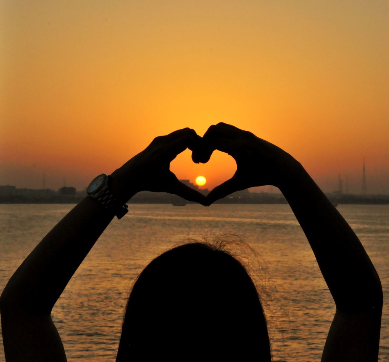 SILHOUETTE WOMAN WITH HEART SHAPE AGAINST SKY DURING SUNSET