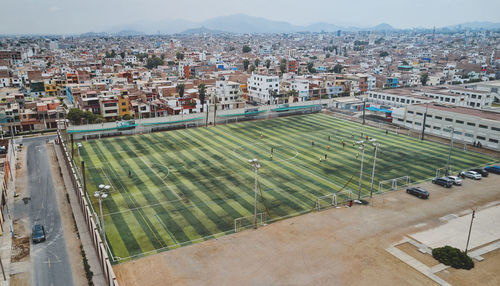 Aerial view of the football field in the middle of a messy neighborhood, callao, lima. peru