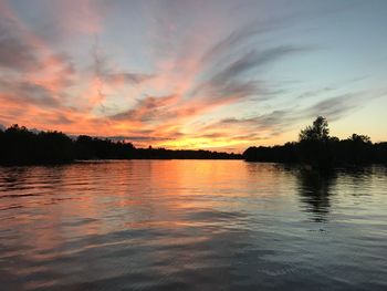 Scenic view of lake against orange sky