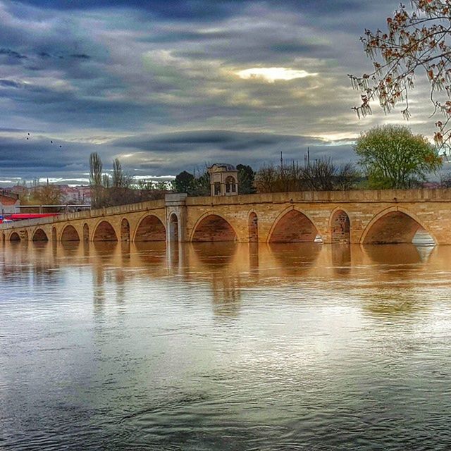 architecture, built structure, connection, water, sky, bridge - man made structure, waterfront, river, cloud - sky, reflection, bridge, cloud, arch, arch bridge, cloudy, tree, tranquility, building exterior, nature, transportation