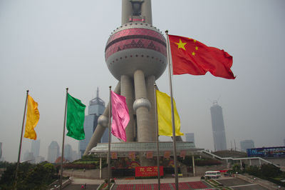 Low angle view of flags against clear sky