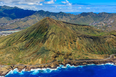 Scenic view of sea and mountains against sky