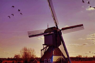 Low angle view of windmill against sky