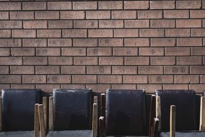 Chairs against brick wall