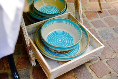 High angle view of ceramics in tray on footpath